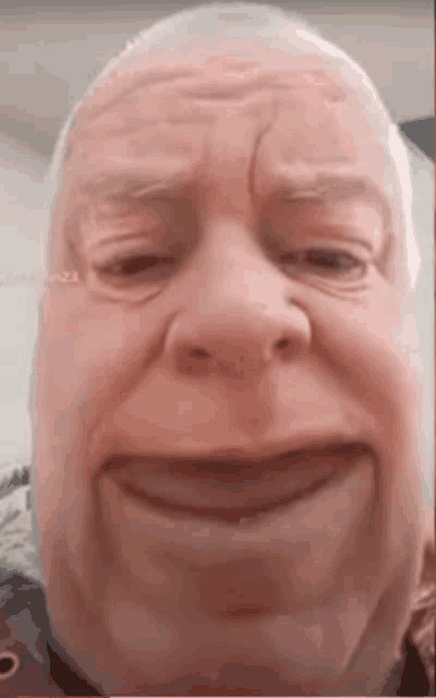 a close up of an older man 's face with a smile