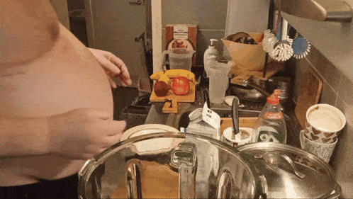 a bottle of aquafina sits on a counter next to a cutting board