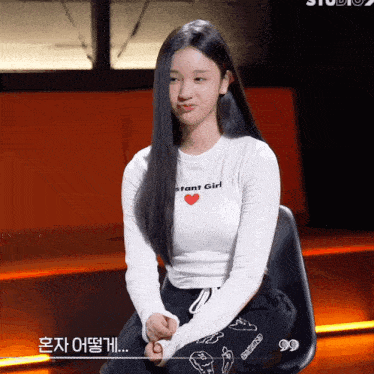a girl wearing a white shirt that says instant girl on it
