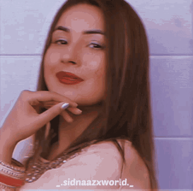 a close up of a woman 's face with the words sidnaazxworld written on the bottom