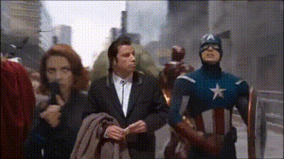a man in a suit stands next to captain america