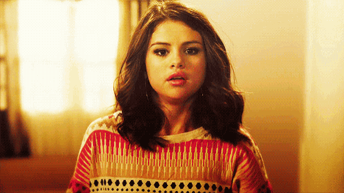 a woman with a surprised look on her face wearing a sweater