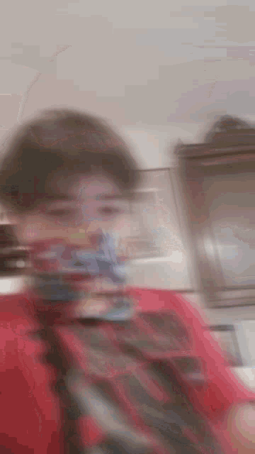 a blurry picture of a person with a scarf around their neck