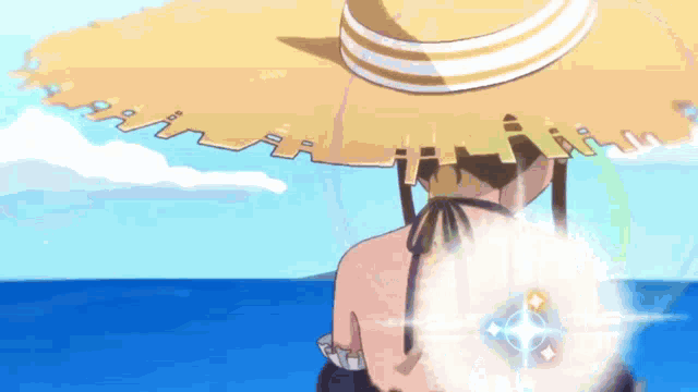 a woman wearing a straw hat and a bikini is standing on a beach .