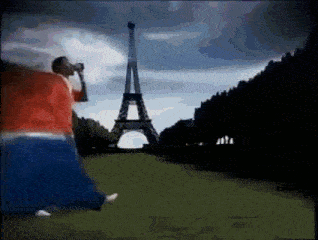 a man is taking a picture of the eiffel tower with a telescope .