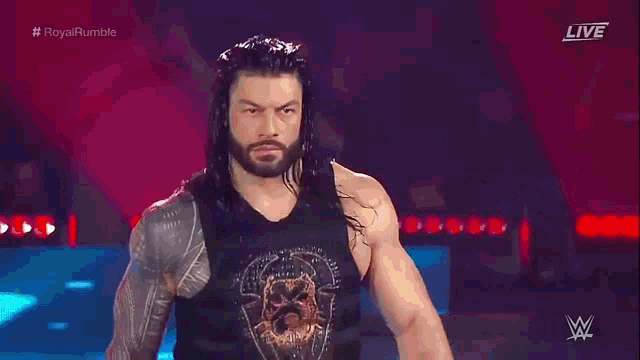 roman reigns is standing in front of a sign that says roman reigns on it