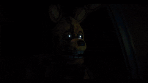 a close up of a bunny with glowing eyes in a dark room