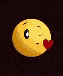 a yellow smiley face is blowing a kiss with a red heart on its cheek .