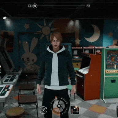 a man is standing in a room with arcade machines and the buttons l2 and r2 are shown