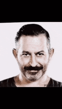 a black and white photo of a man with a beard and jem.beyle written below it