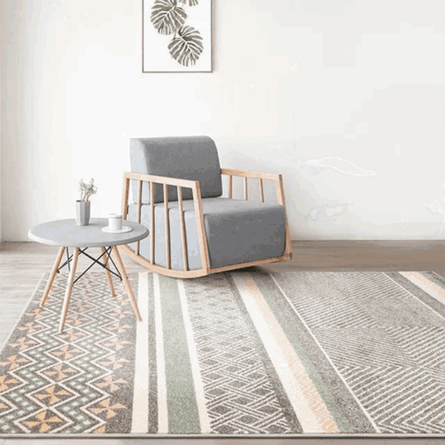 a living room with a rocking chair and a rug on the floor