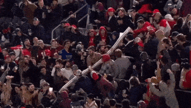 a crowd of people in a stadium with one wearing a sweatshirt that says chicago