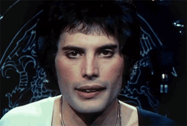 a close up of freddie mercury 's face with a drawing in the background