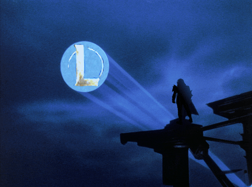 a silhouette of a man standing in front of a blue circle with the letter l on it