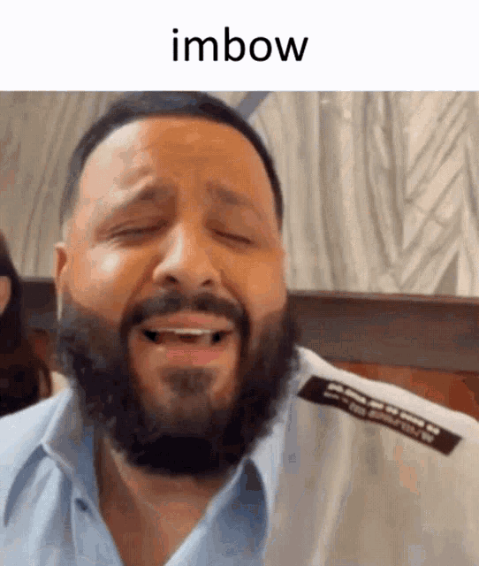a man with a beard is making a funny face and the word imbow is above him
