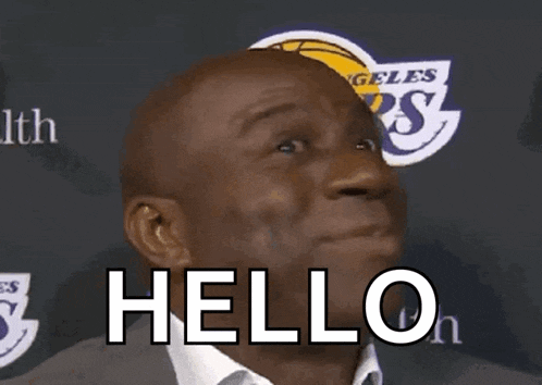 a man in a suit and white shirt says hello