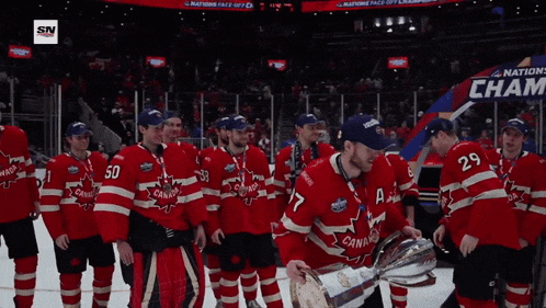 a hockey player holding a trophy in front of a sign that says cham