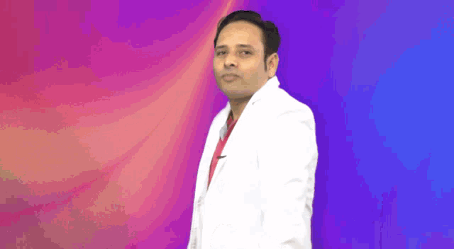 a man in a white coat and red shirt stands in front of a purple and blue background