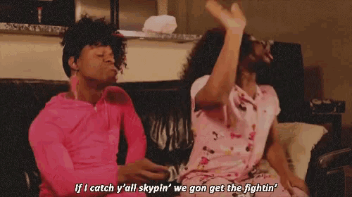 two people sitting on a couch with one saying if i catch y all skypin we gon get the fightin '