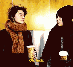 two people standing next to each other with one holding a cup and saying oh fuck