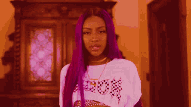 a woman with purple hair is wearing a white shirt that says houston on it
