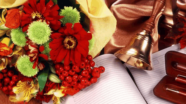 a bouquet of flowers sits on top of an open notebook