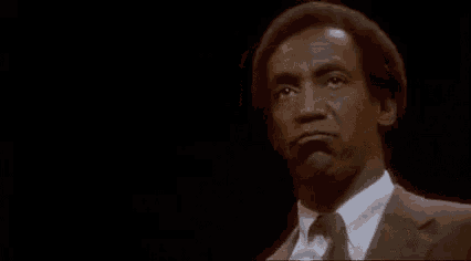a man in a suit and tie is blowing a kiss .