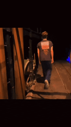 a blurry picture of a man wearing a shirt that says ' abercrombie & fitch '