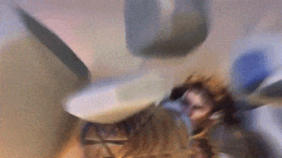 a blurry picture of a person laying on the floor with a hammer in the background .