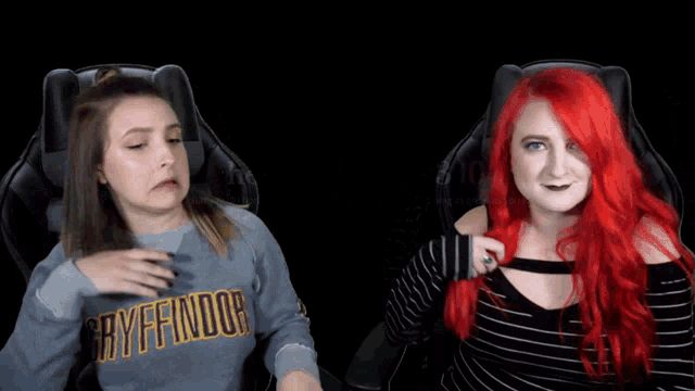 a girl with red hair is wearing a gryffindor sweater