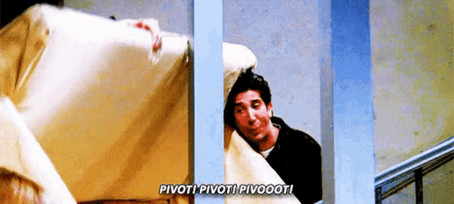 a man is peeking out from behind a fence while holding a blanket and saying pivot !