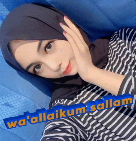 a woman wearing a hijab and a striped shirt with wa ' allaikum salam written on the bottom