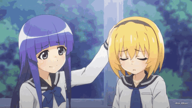 a girl with purple hair is putting her hand on another girl 's forehead