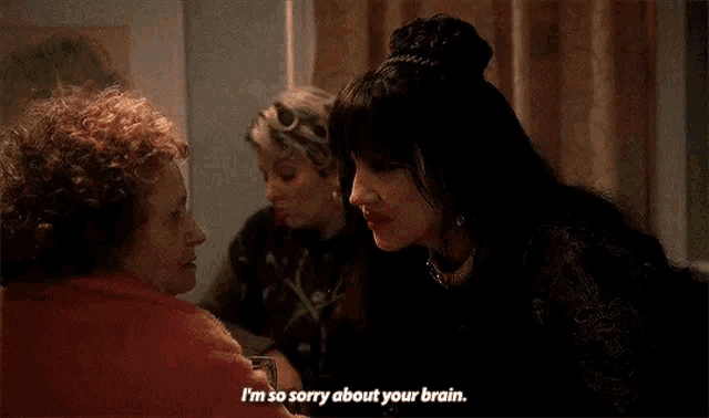 a woman in a black dress is talking to an older woman .