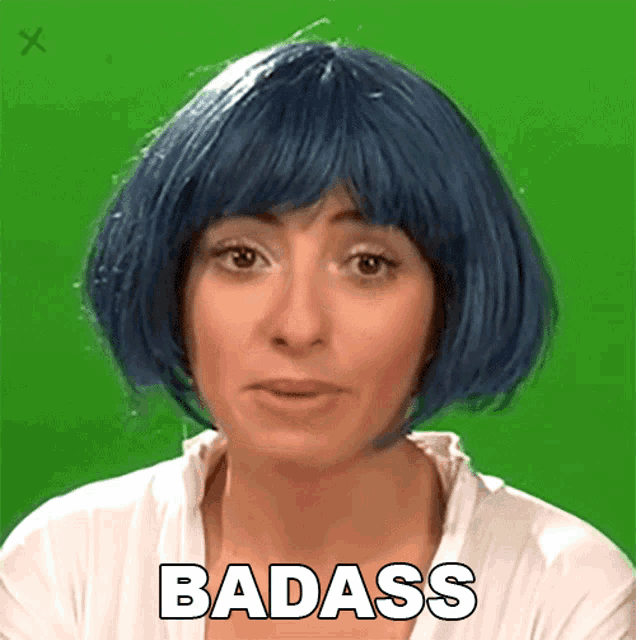 a woman in a blue wig says badass on a green screen