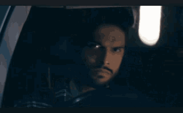 a blurry picture of a man sitting in a car