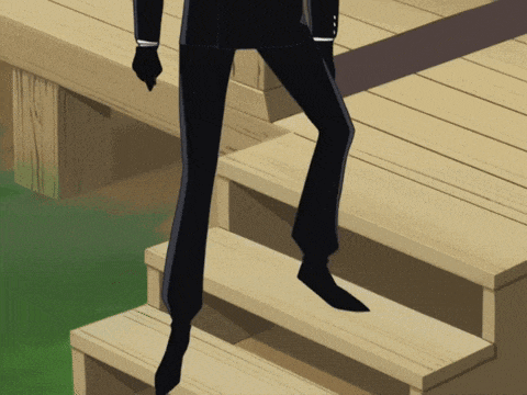 a man in a suit is walking down a set of wooden steps