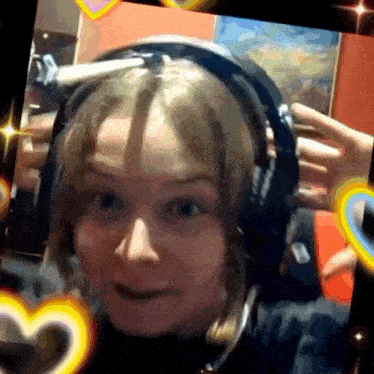 a woman wearing headphones is being photographed on a tablet