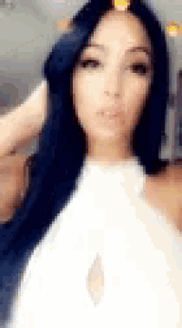 a woman with long blue hair is taking a selfie with her phone .