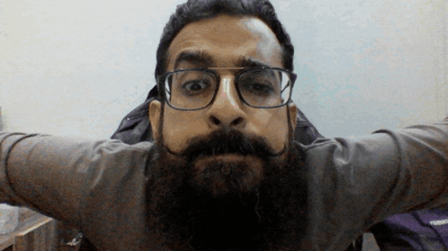 a man with a beard wearing glasses and a mustache
