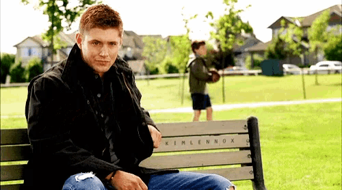 a man sits on a bench that says kimlennox
