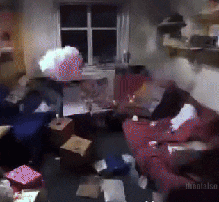 a living room with a red couch and a blue couch with boxes on the floor