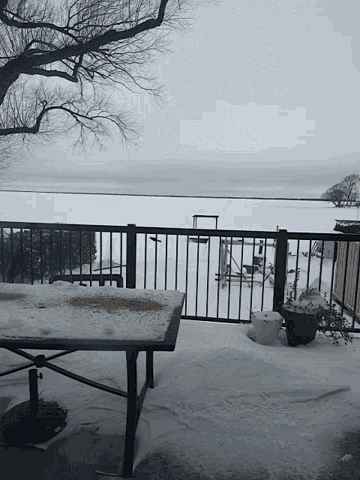 a snowy balcony with a view of the ocean