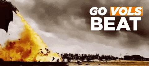 a poster that says go vols beat with a fire coming out of a dragon 's mouth