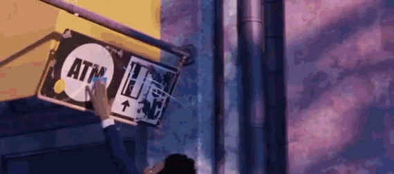 a man is holding a sign that says atm on it