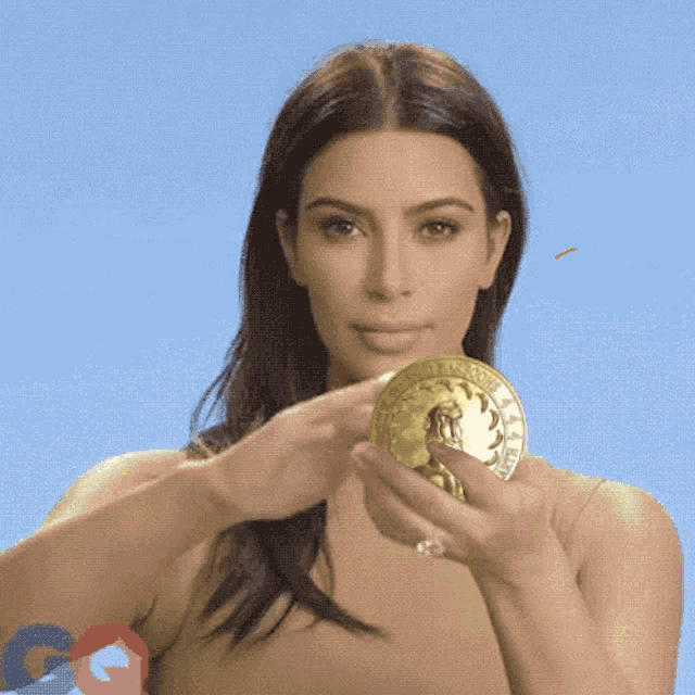 a woman is holding two gold coins in front of her face and one of the coins says " america " on it