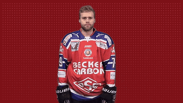 a hockey player is wearing a red and blue jersey with the word carbon on it .