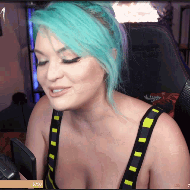 a woman with blue hair is sitting in front of a secret lab gaming chair
