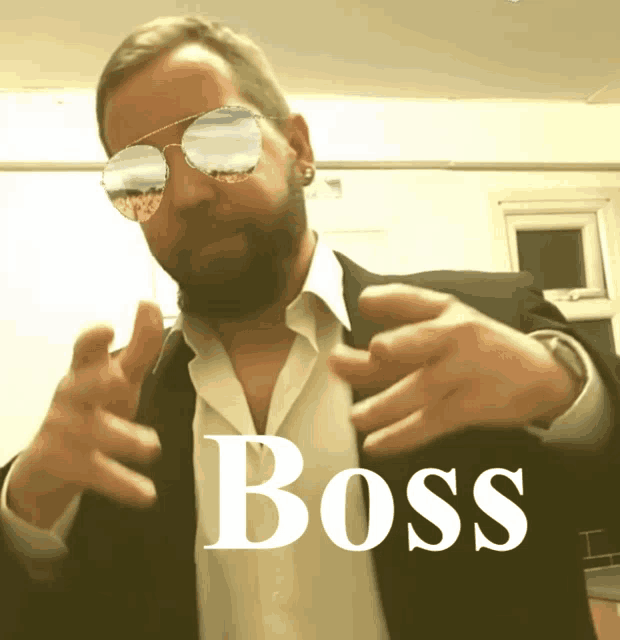 a man wearing sunglasses and a suit has the word boss on the bottom