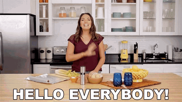 a woman in a kitchen with the words hello everybody